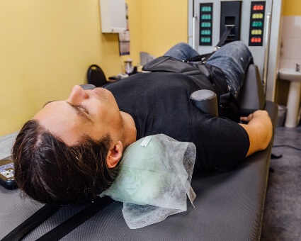 Male patient treated with Intersegmental Traction Therapy