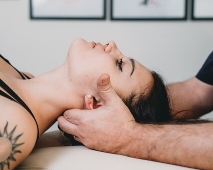 Female patient receiving a gentle neck adjustment