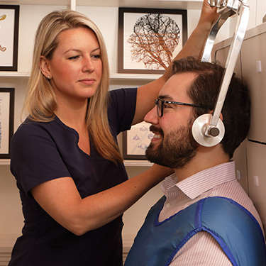 Technician taking x-rays of a patient