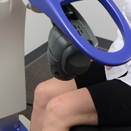 laser therapy on a patient's knee