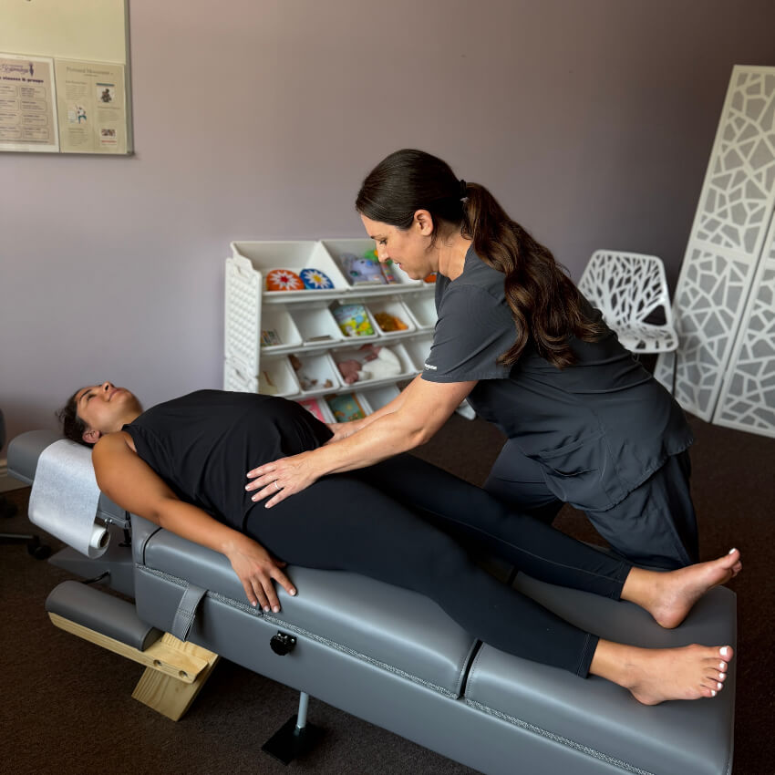 pregnant patient having hips adjusted