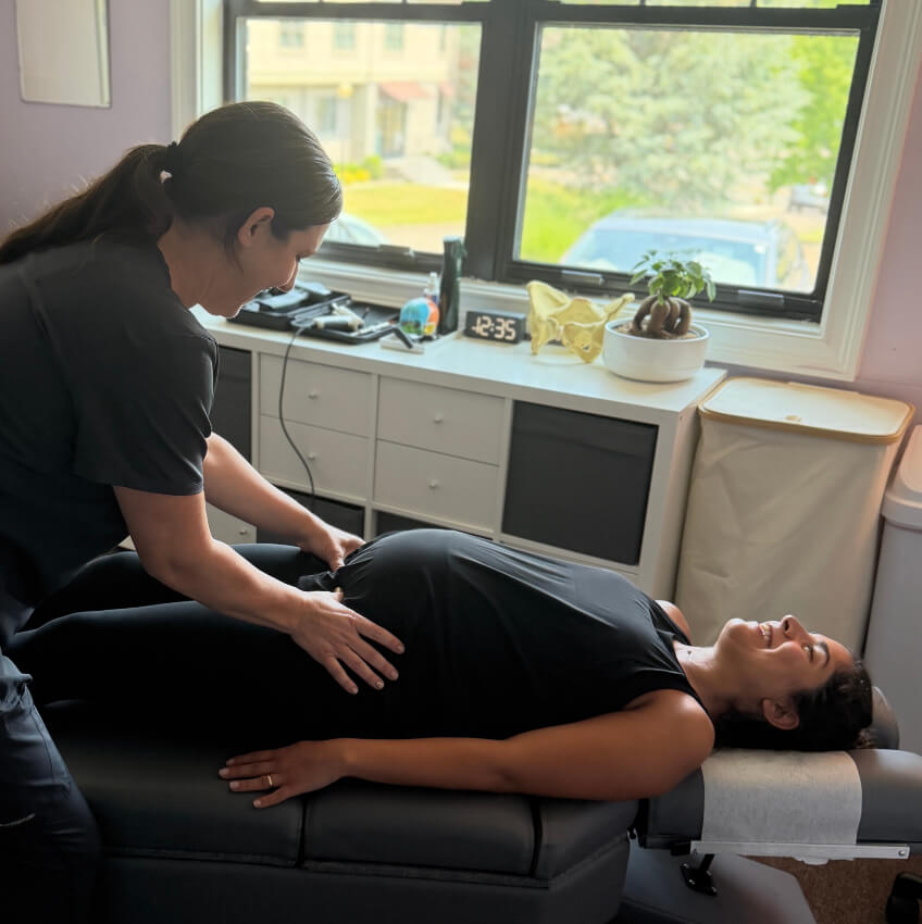 pregnant patient having hips adjusted