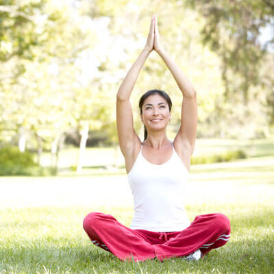 woman doing a yoga pose on grass