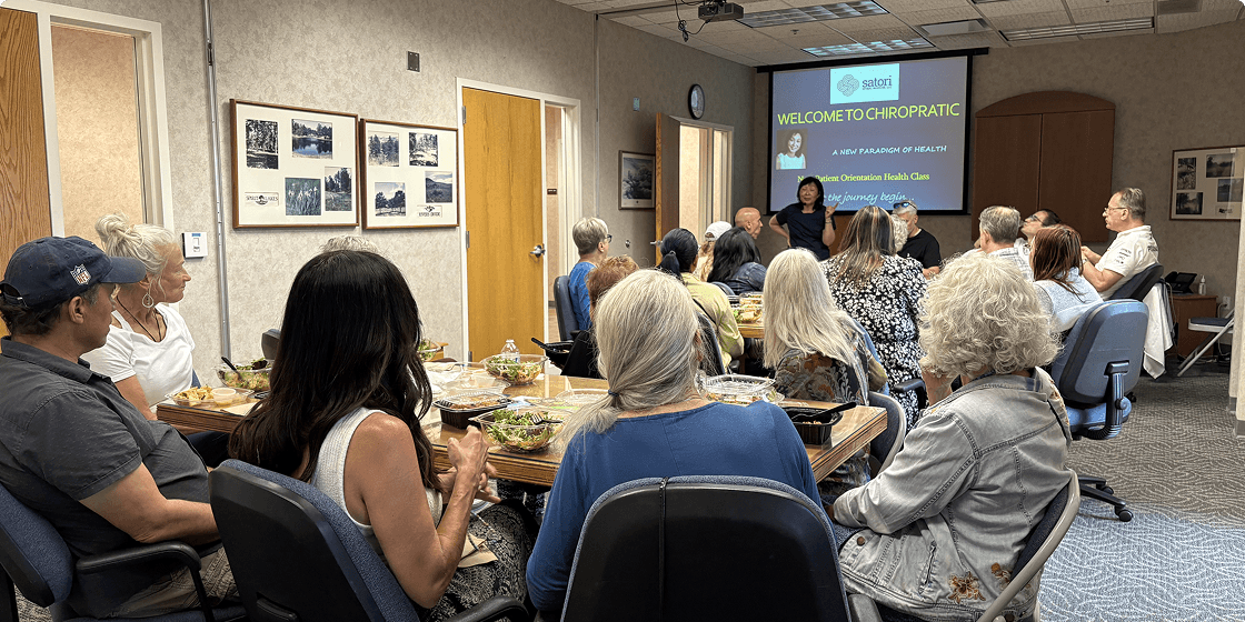 Satori Spinal Wisdom, LLC patients sitting at tables during an eventg