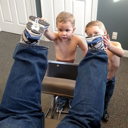 Kids holding man's feet