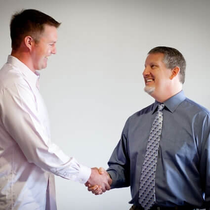 Dr. RJ shaking hands with patient