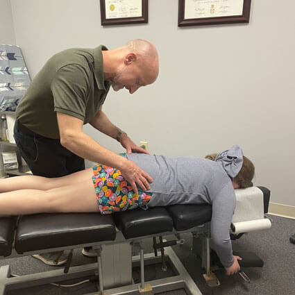 Dr. Eric adjusting patients low back