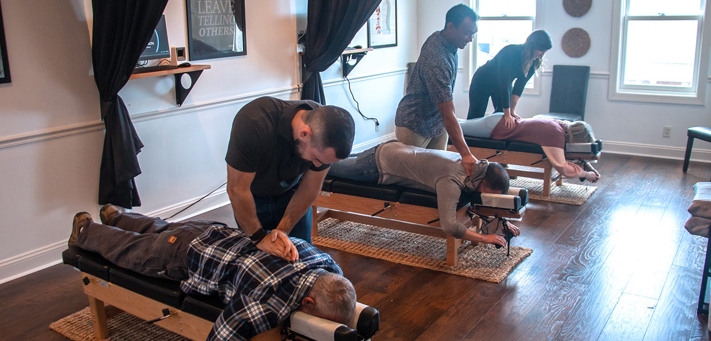 Patients laying on chiropractic tables