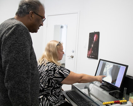 Dr Emily of YourBack Chiropractic reviewing xrays with patient