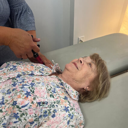 adjusting woman's shoulder