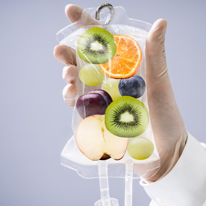 hand holding IV bag with fruits