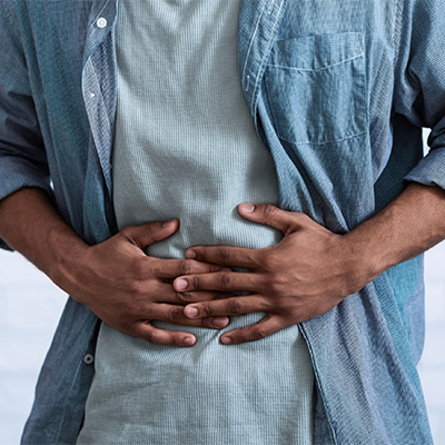man standing with stomach pain