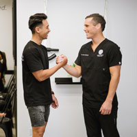 chiropractor and patient shaking hands