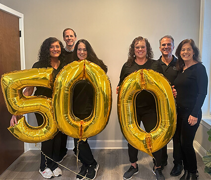 Ballas Chiropractic team with 500 reviews balloons