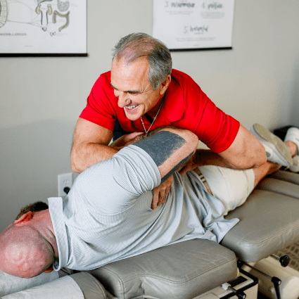  dr-adjusting-patient-spine-on-table-