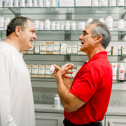 Dr Ballas talking to patient by supplements