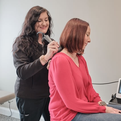 Staff using laser on upper back