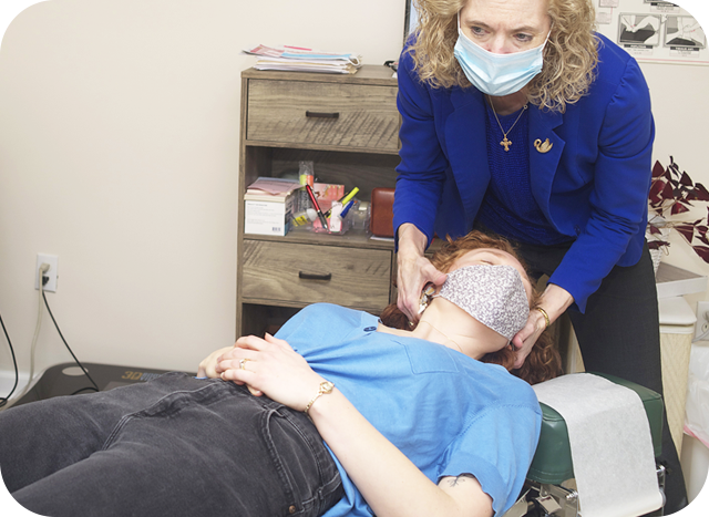 Dr. Mason adjusting patients neck