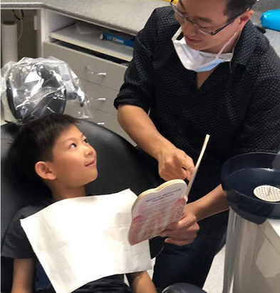 dentist showing book to child