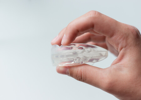 Man holding a mouthguard