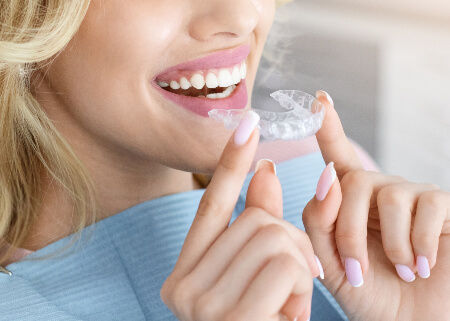 Woman fitting Angel Align Clear Braces