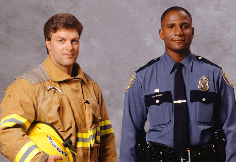 Firefighter and police man smiling