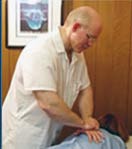 Toledo Chiropractor Dr. Pickens makes a precise spinal adjustment.