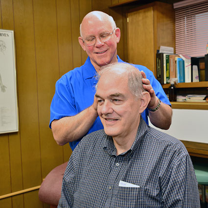 Dr Pickens adjusting patients neck