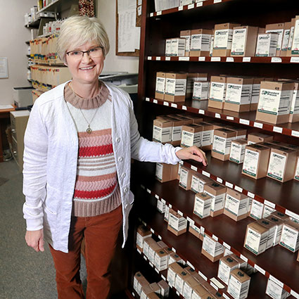 Nancy standing near shelf of supplements