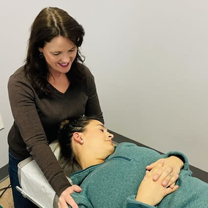 Dr. Beth stretching patient neck