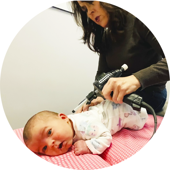 Dr. Beth adjusting infant
