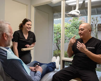 Dentist talking to man in chair