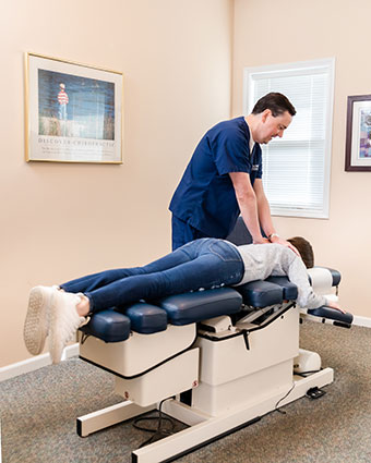 Dr Dan adjusting patient on table