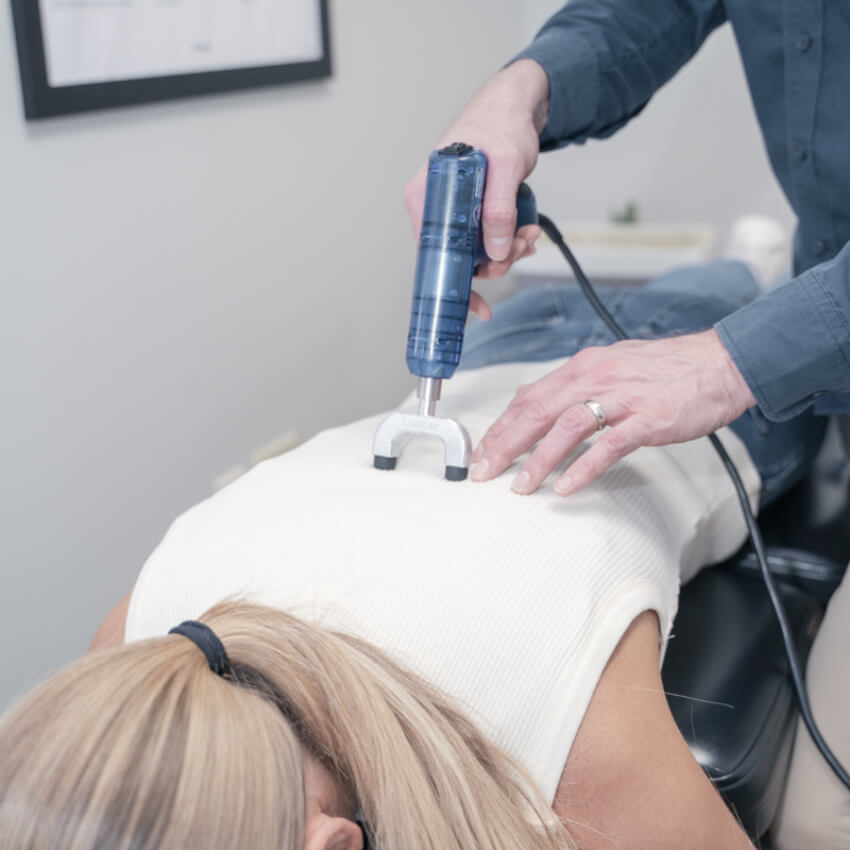 patient having back adjusted with a tool