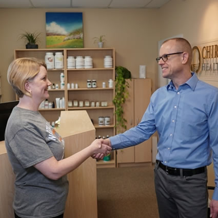 Dr. Ritchie shaking hands with patient