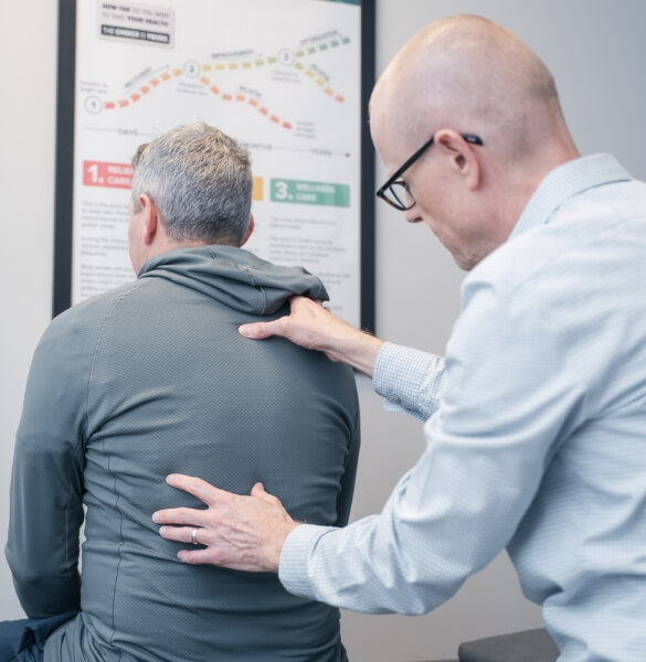 Chiropractor Dr. David Ritchie adjusting man's back