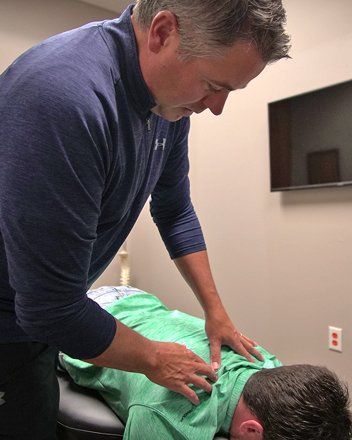 doctor with hands on patient back