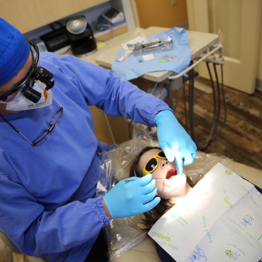 Columbia dentist checking girls teeth