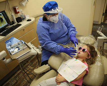 Child getting teeth cleaned