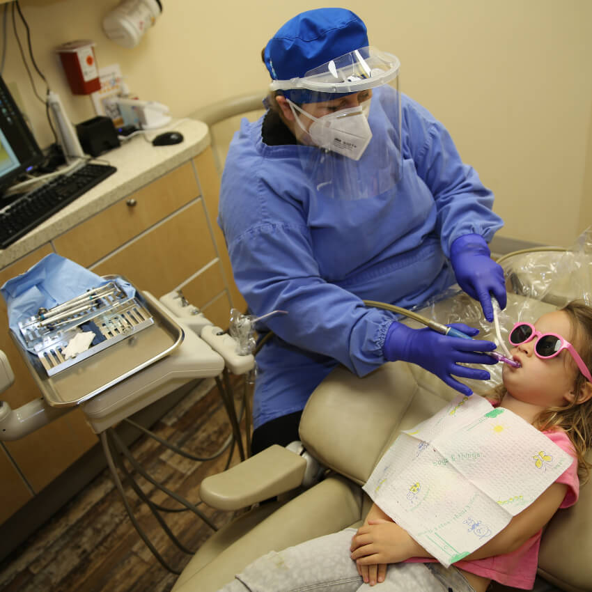 hygienist cleaning Crafton Dental patient's teeth
