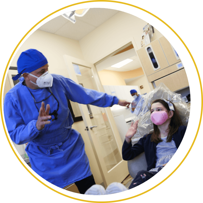 Dentist waving to  kid patient