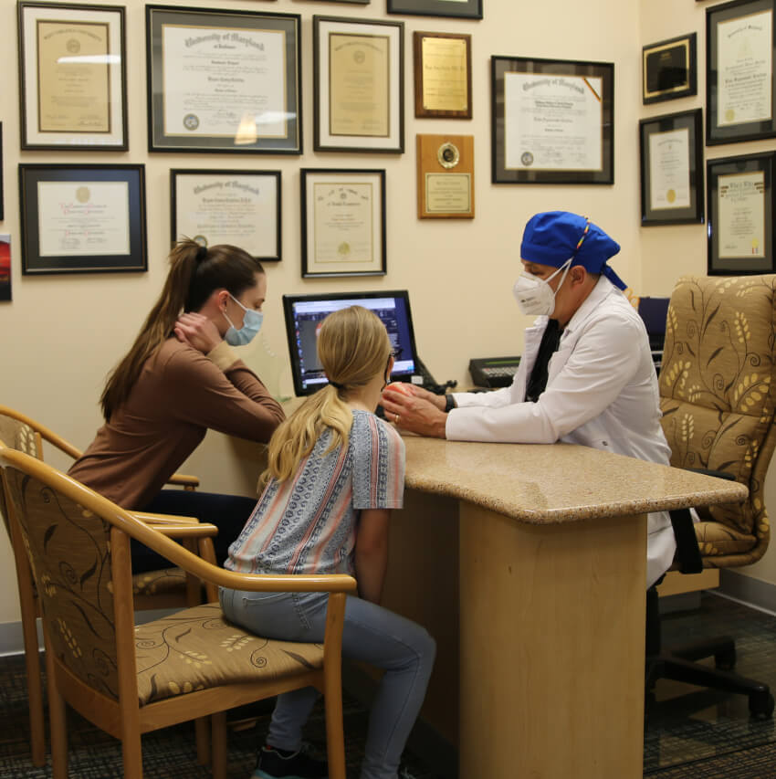 patients looking at scans with dentist
