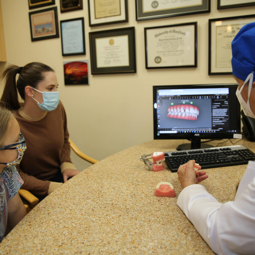 patients looking at scans with dentist