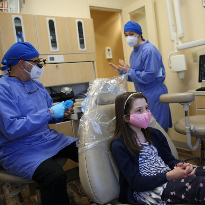 girl sitting in dentists chair