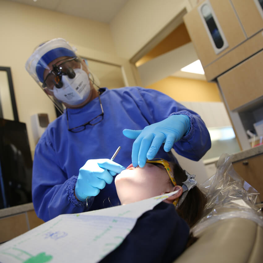Crafton Dental dentist working on woman's teeth