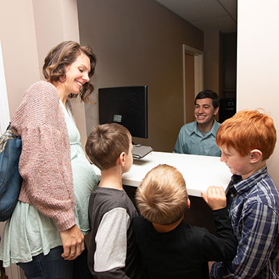 mom and kids at the check in desk