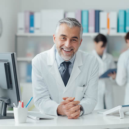 doctor smiling at desk