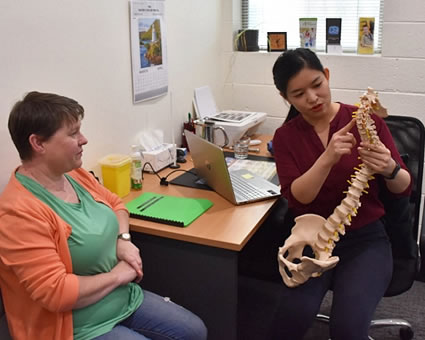 Doctor pointing spine model