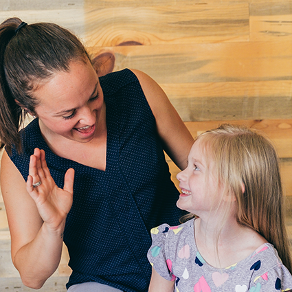 chiropractor high fiving a smiling child