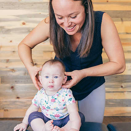 chiropractor adjusting baby